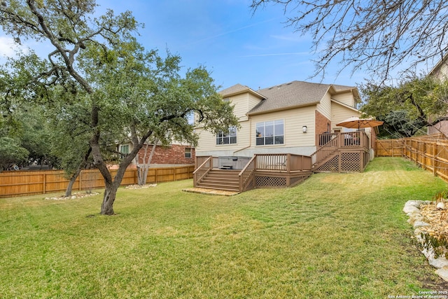 rear view of house with a lawn and a deck