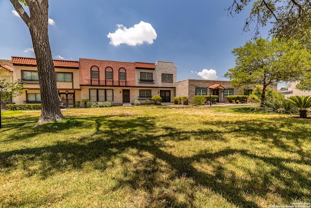 rear view of house featuring a lawn