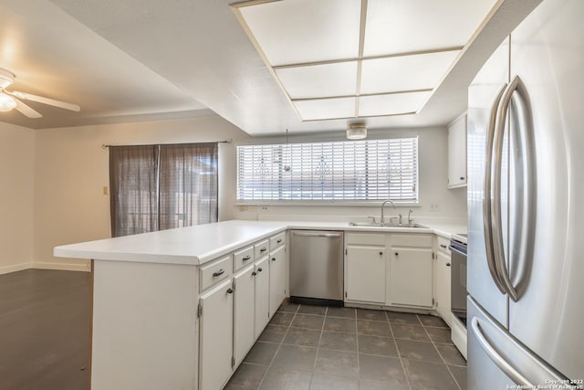 kitchen featuring white cabinetry, appliances with stainless steel finishes, sink, and kitchen peninsula