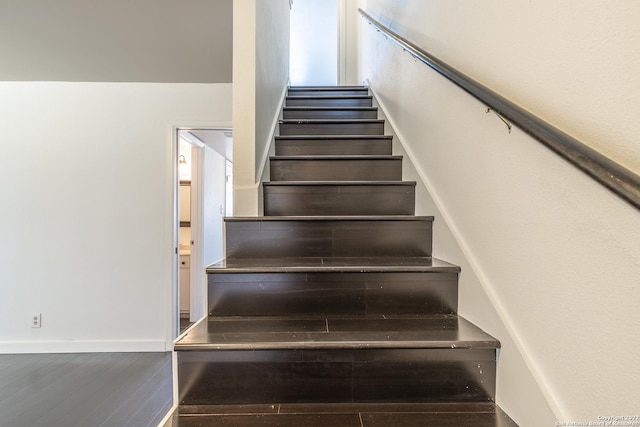 stairs with hardwood / wood-style flooring