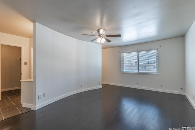 spare room with dark hardwood / wood-style floors and ceiling fan