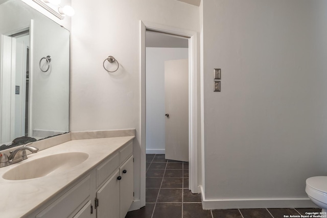 bathroom with vanity, tile patterned floors, and toilet