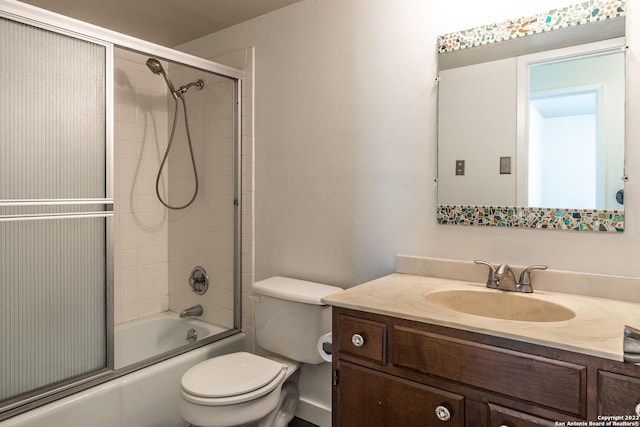 full bathroom with vanity, toilet, and combined bath / shower with glass door