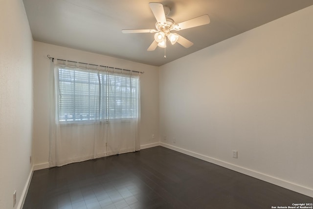 empty room featuring ceiling fan and dark hardwood / wood-style flooring