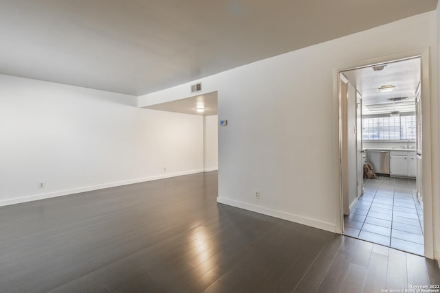 empty room featuring dark hardwood / wood-style flooring and sink