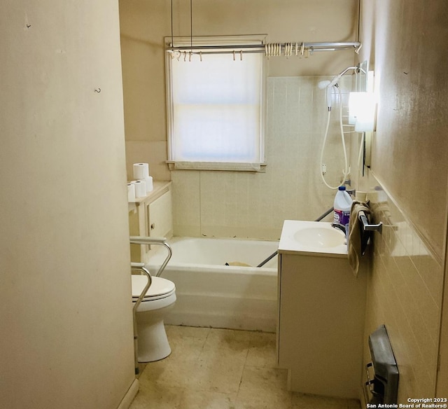 full bathroom with shower / bathtub combination, tile walls, tile patterned flooring, vanity, and toilet