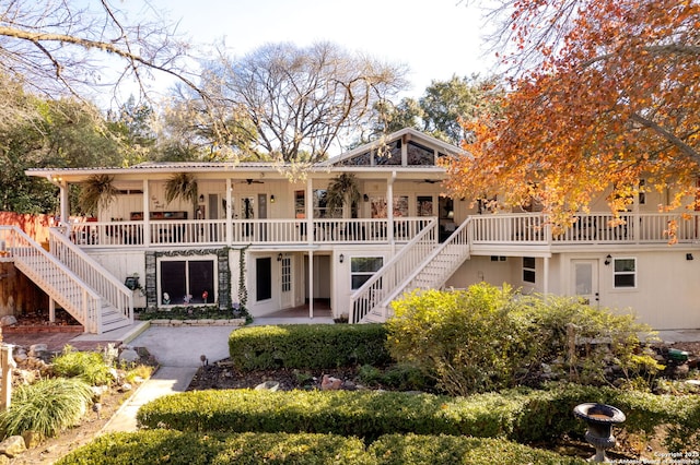 rear view of house with covered porch and a patio area