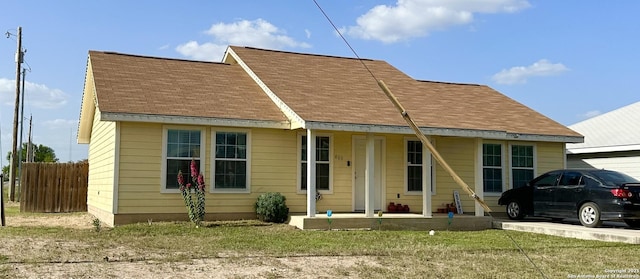 view of front of house featuring a front lawn and covered porch