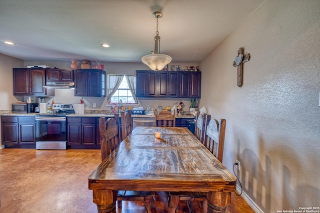 interior space featuring stainless steel appliances and hanging light fixtures