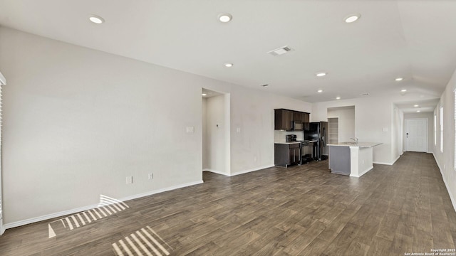 unfurnished living room featuring dark hardwood / wood-style flooring and sink