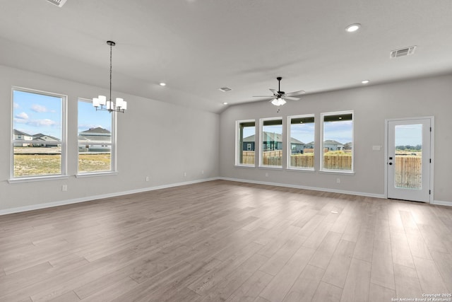 interior space with lofted ceiling, ceiling fan with notable chandelier, and light hardwood / wood-style flooring