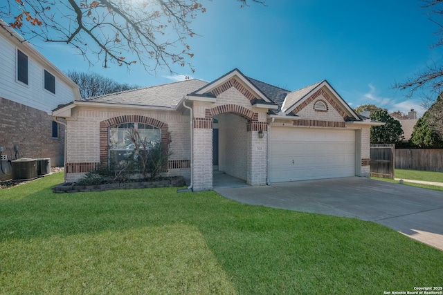 view of front of house featuring cooling unit, a garage, and a front yard