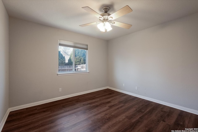 empty room featuring ceiling fan and dark hardwood / wood-style flooring