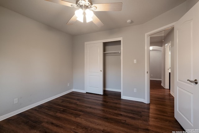 unfurnished bedroom featuring dark hardwood / wood-style floors, ceiling fan, and a closet