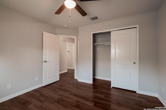 unfurnished bedroom with dark hardwood / wood-style flooring, ceiling fan, and a closet