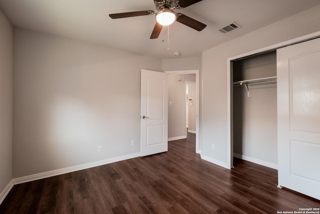 unfurnished bedroom with dark wood-type flooring, a closet, and ceiling fan