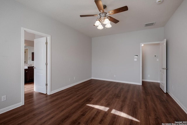 spare room featuring dark wood-type flooring and ceiling fan