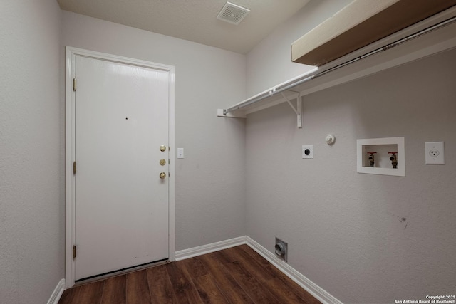 washroom with washer hookup, dark hardwood / wood-style flooring, hookup for a gas dryer, and electric dryer hookup