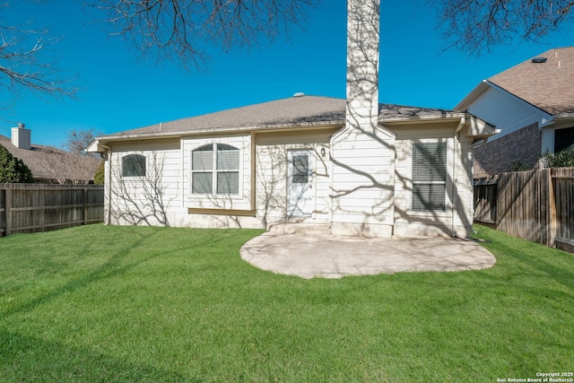 rear view of house featuring a yard and a patio area