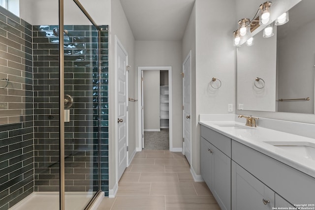 bathroom with tile patterned floors, a shower with door, and vanity