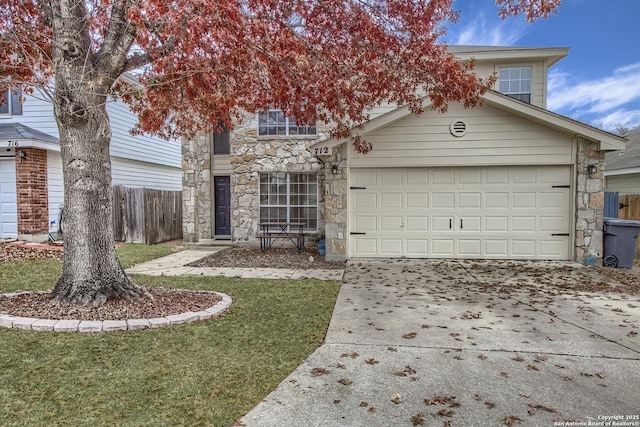 view of front of property featuring a garage and a front yard