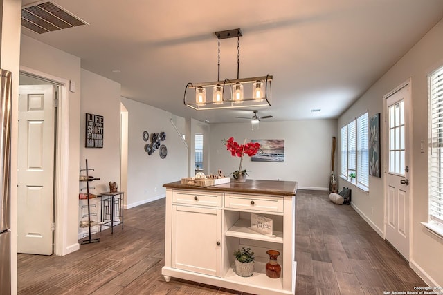 kitchen with pendant lighting, white cabinetry, dark hardwood / wood-style flooring, and ceiling fan