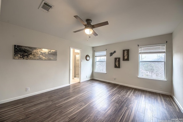 spare room with dark hardwood / wood-style flooring and ceiling fan