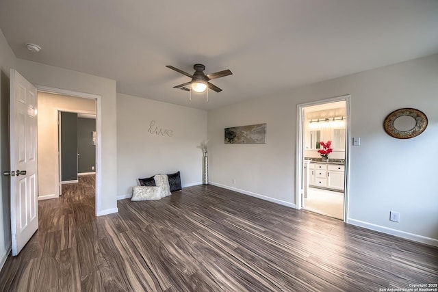 unfurnished living room featuring ceiling fan and dark hardwood / wood-style flooring