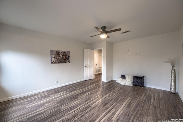 unfurnished room featuring dark wood-type flooring and ceiling fan