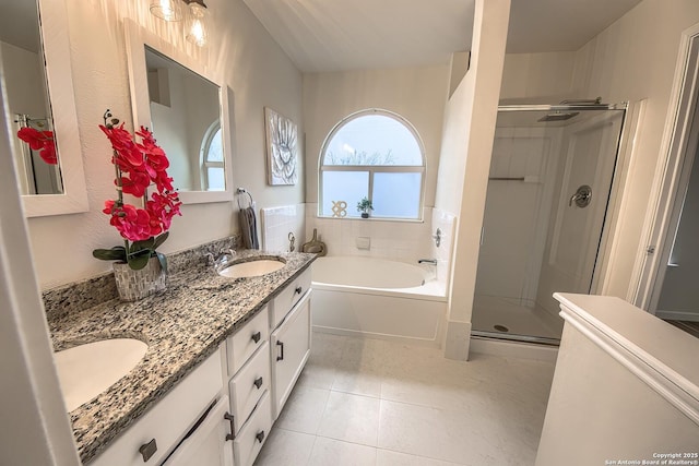 bathroom with tile patterned flooring, vanity, and independent shower and bath