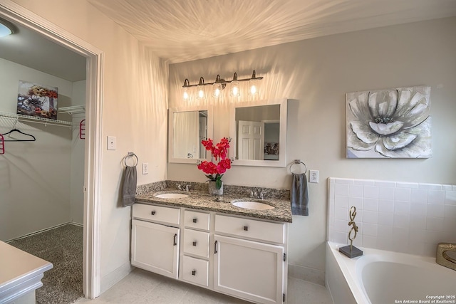 bathroom featuring vanity and a bath