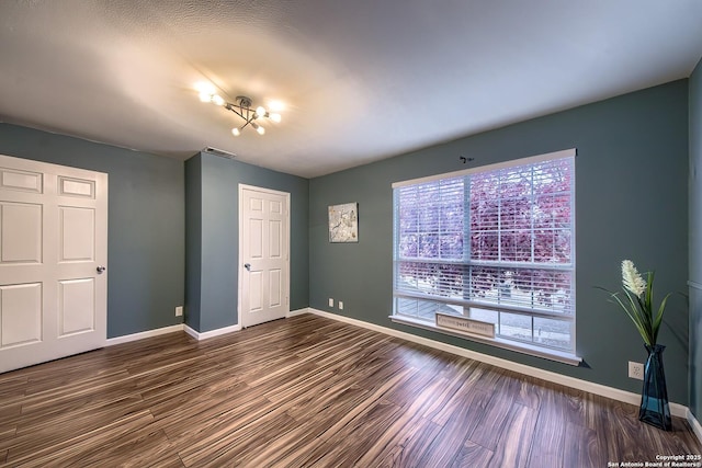 unfurnished bedroom with dark hardwood / wood-style flooring