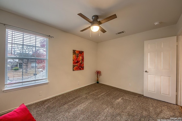 carpeted empty room featuring ceiling fan