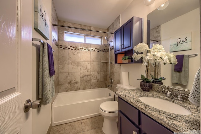 full bathroom featuring tile patterned flooring, vanity, toilet, and tiled shower / bath