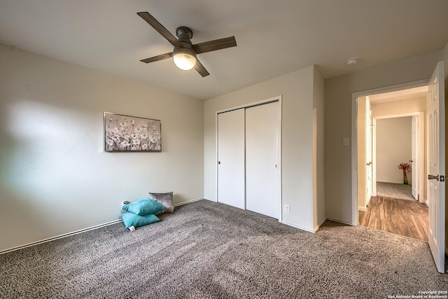 unfurnished bedroom with carpet floors, ceiling fan, and a closet