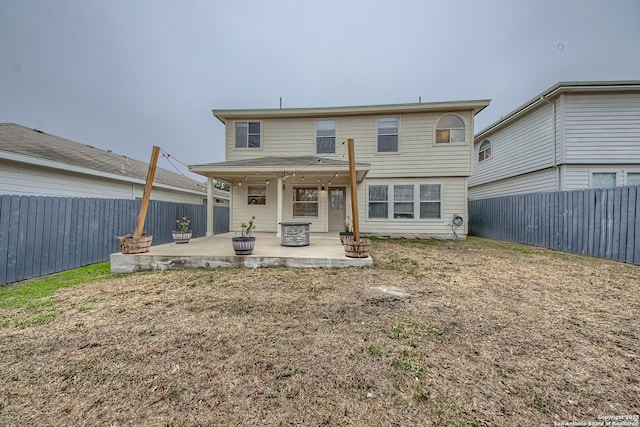 rear view of property featuring a patio area