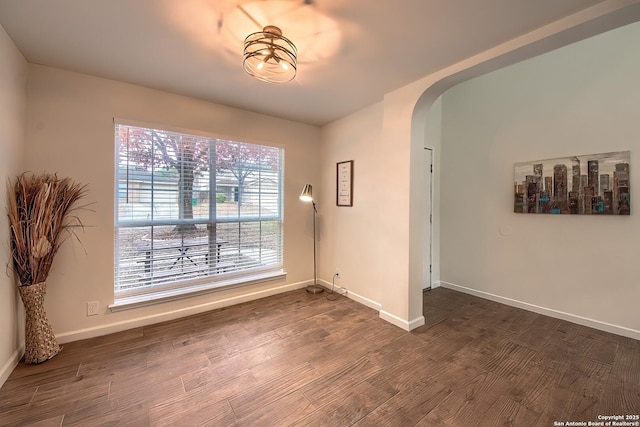 empty room with dark hardwood / wood-style floors