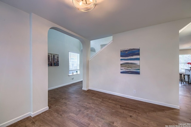 empty room featuring dark hardwood / wood-style flooring and a wealth of natural light