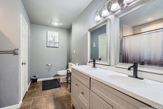 bathroom featuring vanity, toilet, and a shower with shower curtain