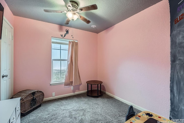 interior space featuring ceiling fan, a textured ceiling, and carpet flooring