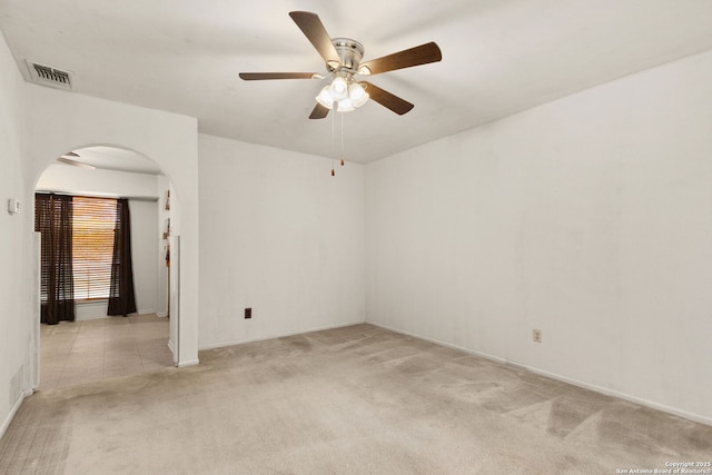 carpeted spare room featuring ceiling fan