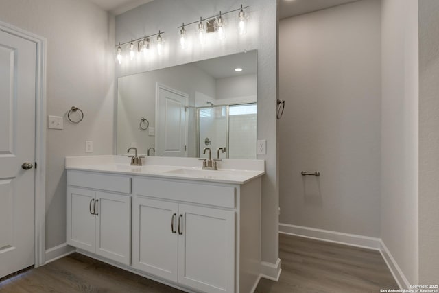 bathroom with vanity, hardwood / wood-style flooring, and walk in shower