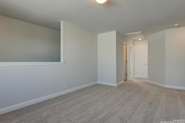 unfurnished room featuring light colored carpet and a textured ceiling