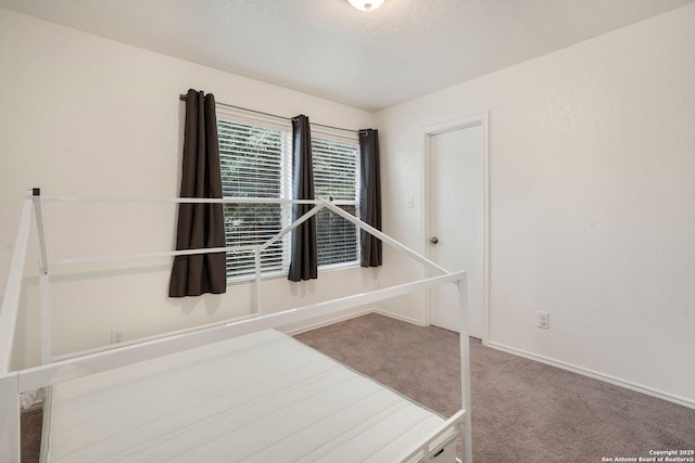 unfurnished bedroom with carpet floors and a textured ceiling