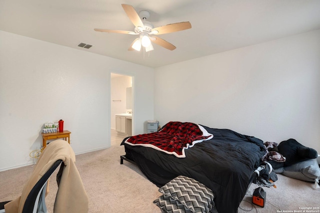 carpeted bedroom with ceiling fan and ensuite bathroom