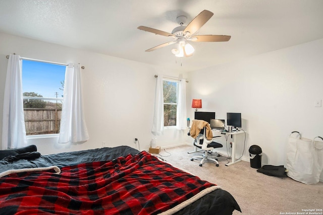 bedroom featuring ceiling fan and carpet