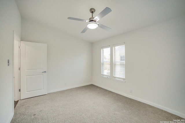 spare room featuring ceiling fan and light colored carpet