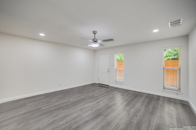 spare room with ceiling fan and wood-type flooring