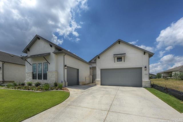 view of front of home with a garage and a front lawn