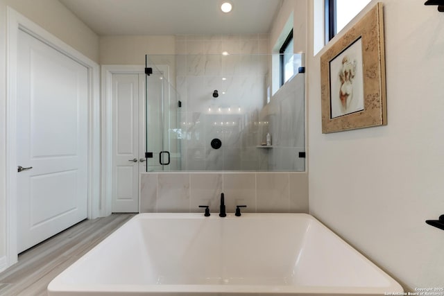 bathroom with shower with separate bathtub